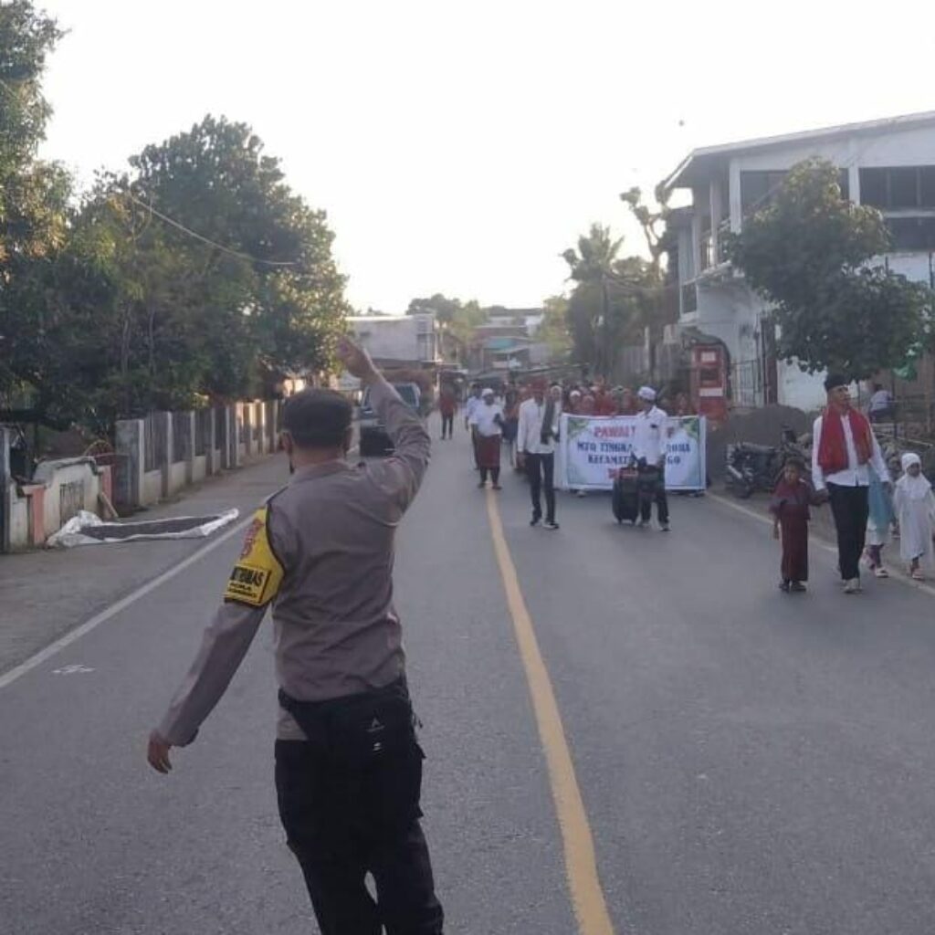 Bhabinkamtibmas Polsek Donggo Laksanakan Pengamanan Pawai Ta’aruf Pembukaan MTQ Tingkat Desa Rora