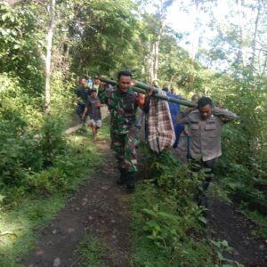 Bhabinkamtibmas dan Warga Marente Tandu Pasien Melewati Akses Jalan Rusak