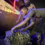 Personel Polri Bersihkan Lumpur dan Sampah Pascabanjir di Jalan Lintas Aceh Tamiang